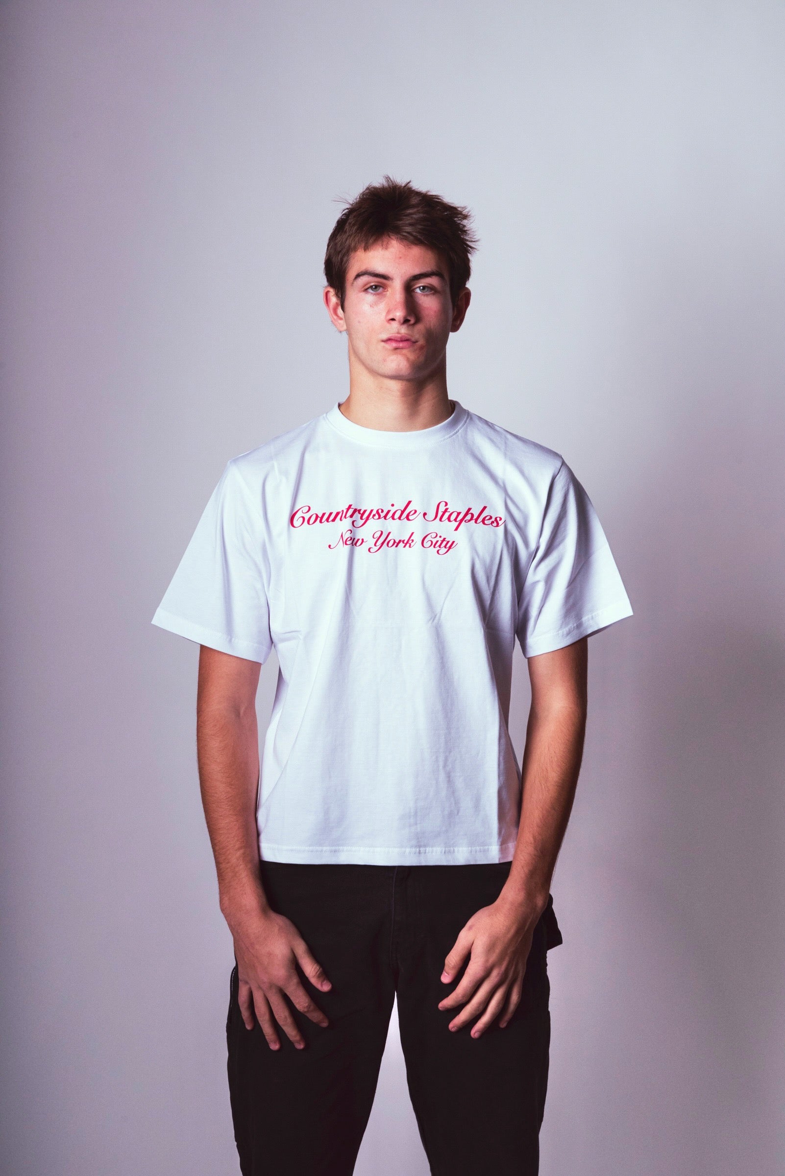 Model wearing Countryside Staples New York City tee with logo center of shirt