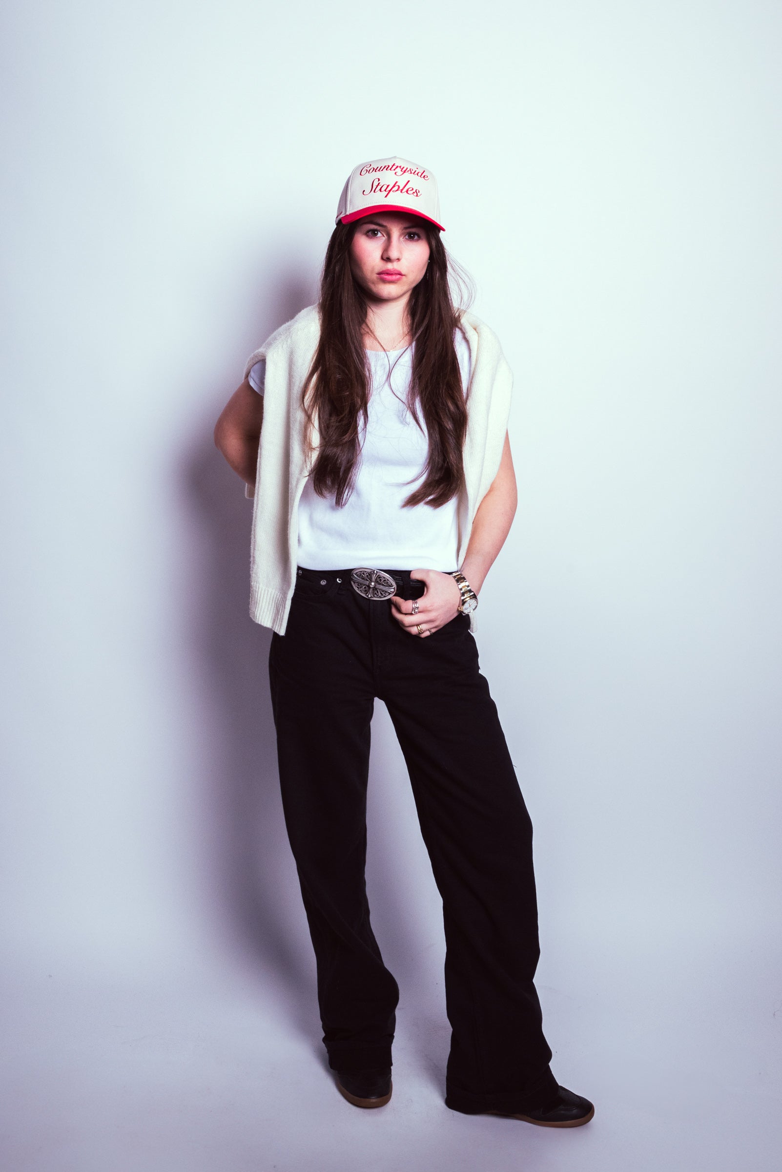 Model wearing Friends and Family Countryside Staples Hat styled with Isabel Marants and cream sweater.