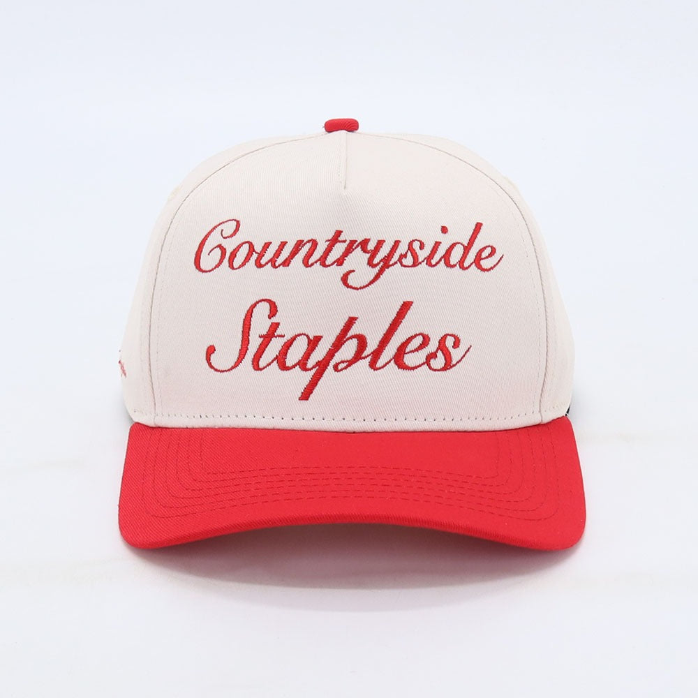 Friends and Family Countryside Staples Hat laid flat on a white background front view with embroidered logo.