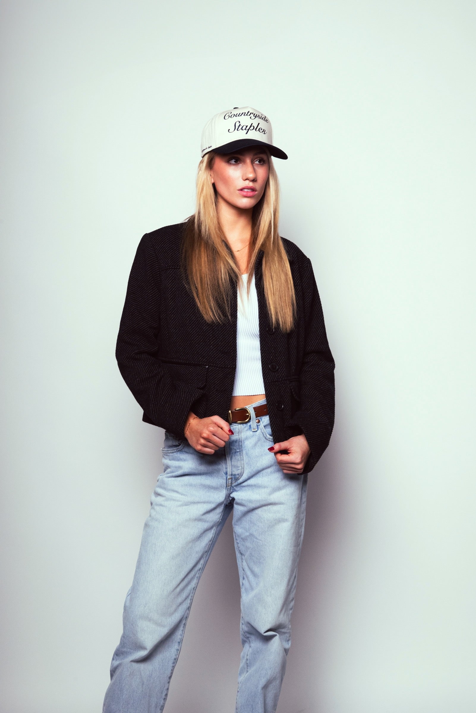 Model wearing Signature Navy & Cream Countryside Staples Hat with black blazer and light blue jeans.