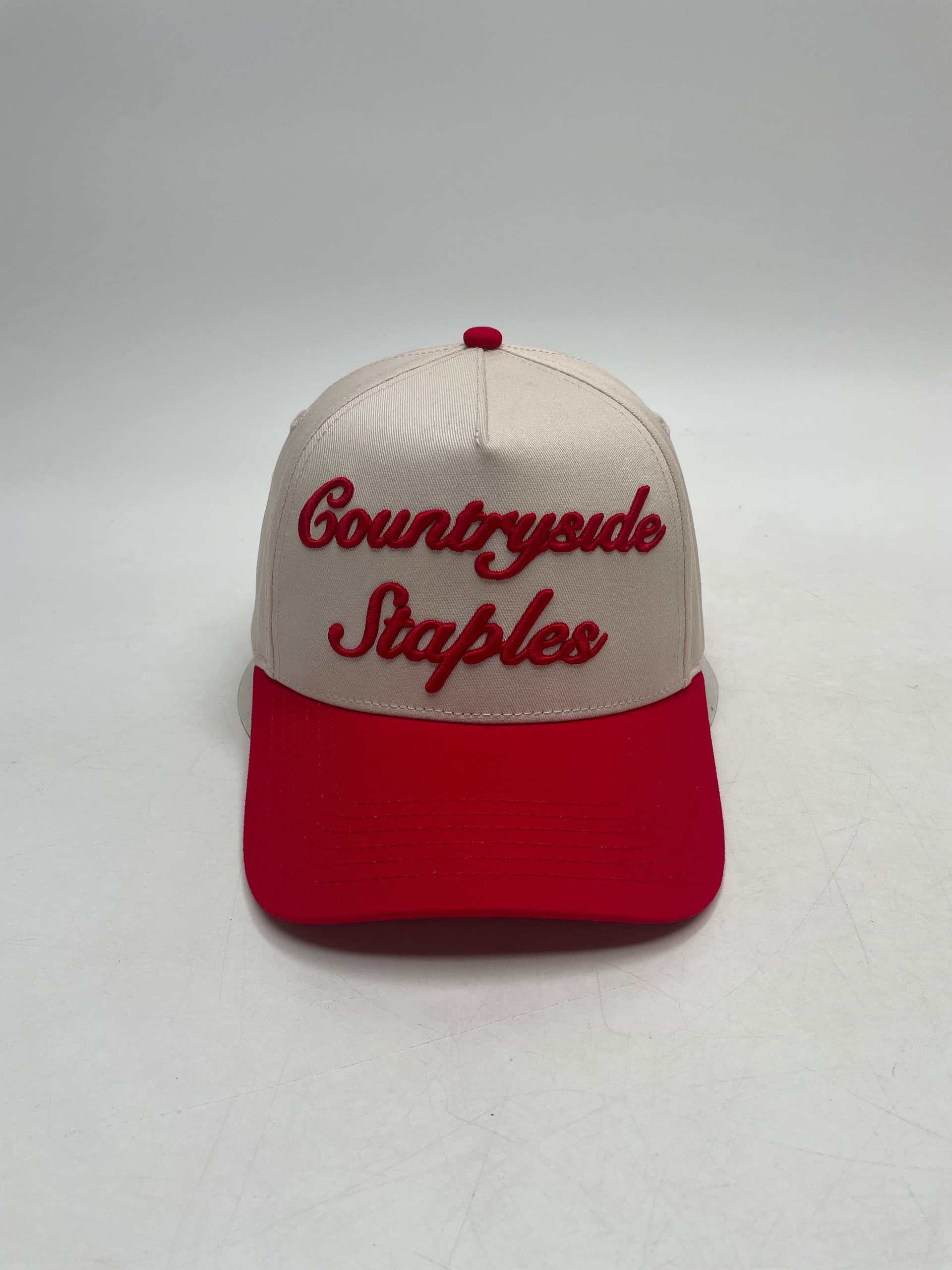 Signature Red & Cream Countryside Staples Hat with 3D embroidered logo laid flat on a white background front view.